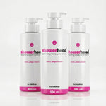 Three bottles of 'showerhead' exfoliating body wash scrub on a white background
