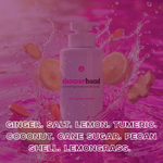 Showerhead body wash scrub bottle with ingredients listed on a pink water splash background
