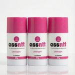Three bottles of 'assntt' all natural intimate deodorant with pink caps on a white background.